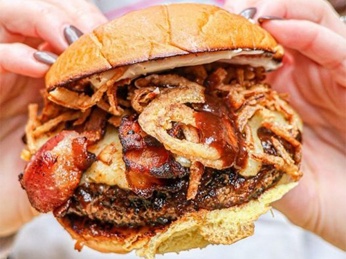 Burger with bacon and onion strings served at our Civic Center burger restaurant.