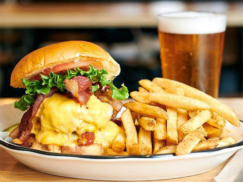 Cheeseburger, fries and a beer at our burger restaurant near Color Factory, New York City.