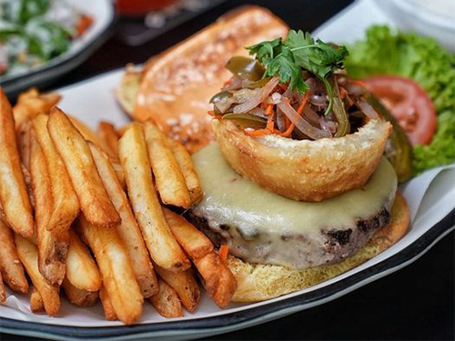Cheeseburger with onion on top and French fries at our Hudson Square burger place.