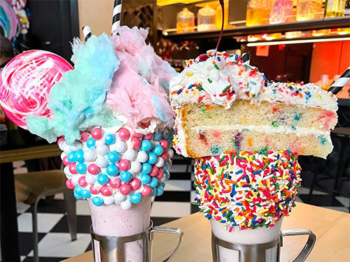 Close up of two of our shakes near Alphabet City, New York City, the Cotton Candy shake and the Cakeshake®.
