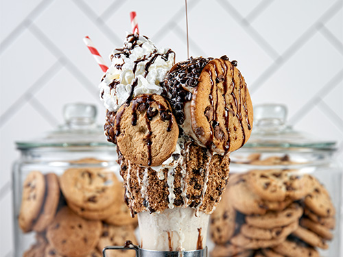 Close up view of the Two Bridges Cookie Shake with cookie jars behind it.