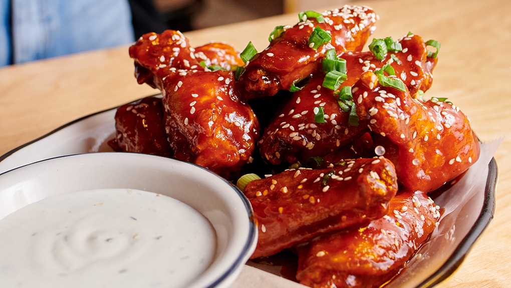 Korean BBQ wings with Buttermilk-Dill dipping sauce served at our chicken wing restaurant near Theater District, New York City.