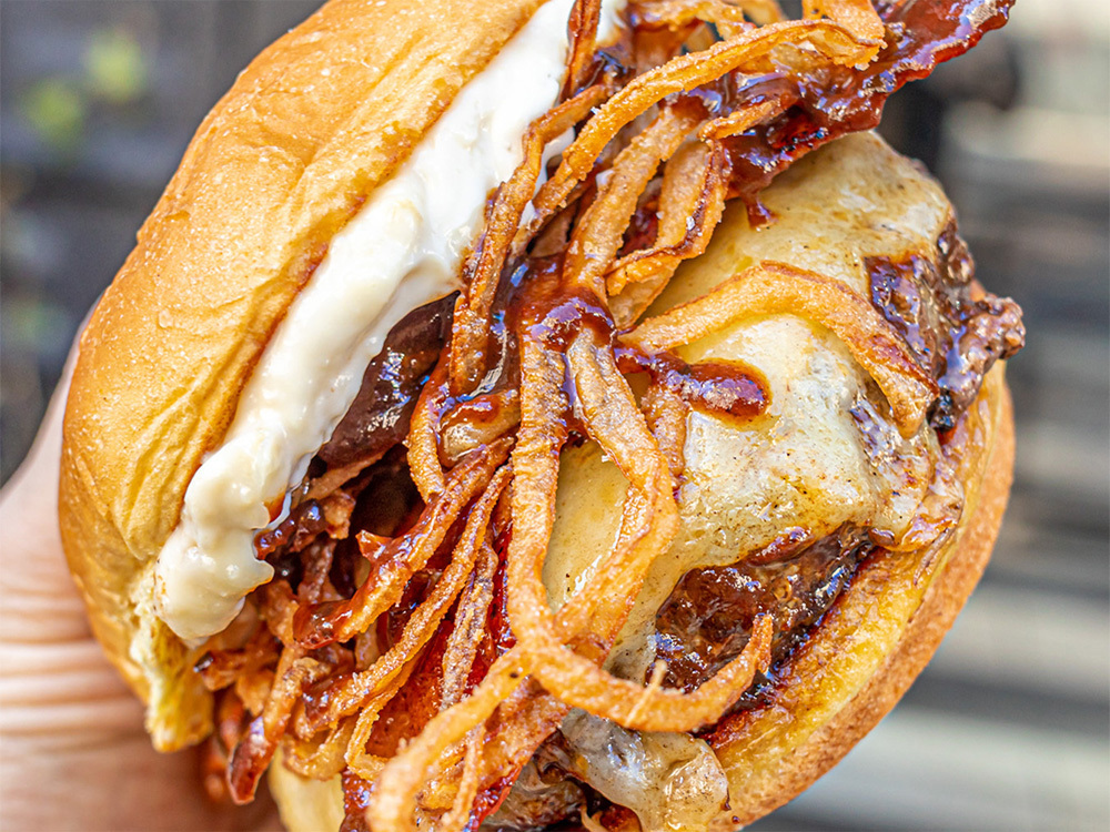 Close up view of the Wagyu Steakhouse Burger, a popular choice at our Turtle Bay burger delivery restaurant.