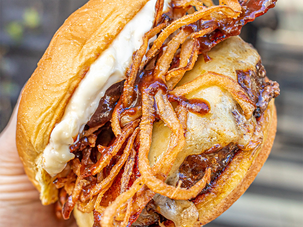 Close up view of the Wagyu Steakhouse Burger, a popular choice at our West Village burger delivery restaurant.