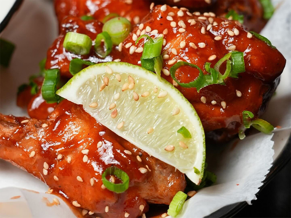 Close up of Korean BBQ Chicken Wings, a go-to for wings delivery near Alphabet City, NYC.