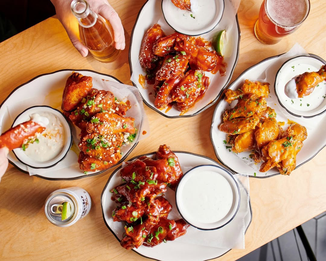 Four plates of chicken wings at our wing restaurant near Maryland, London, United Kingdom.